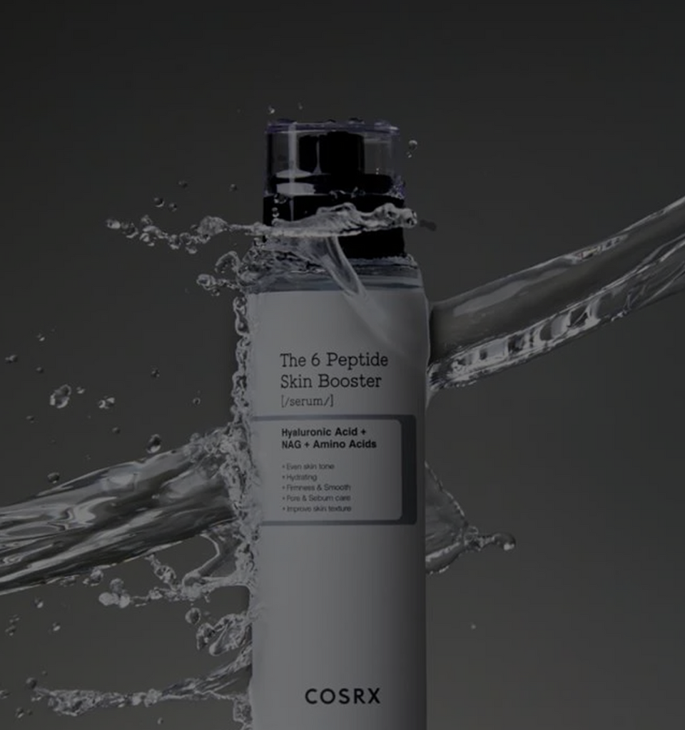 COSRX The 6 Peptide Skin Booster Serum bottle splashing through water on a dark gradient background, text reads '1 Serum, 6 Peptides' and 'Perfect First-Step Booster'; highlights the Korean peptide serum’s hydrating and firming power for youthful glow and healthy aging, ideal for first-step skincare routines.