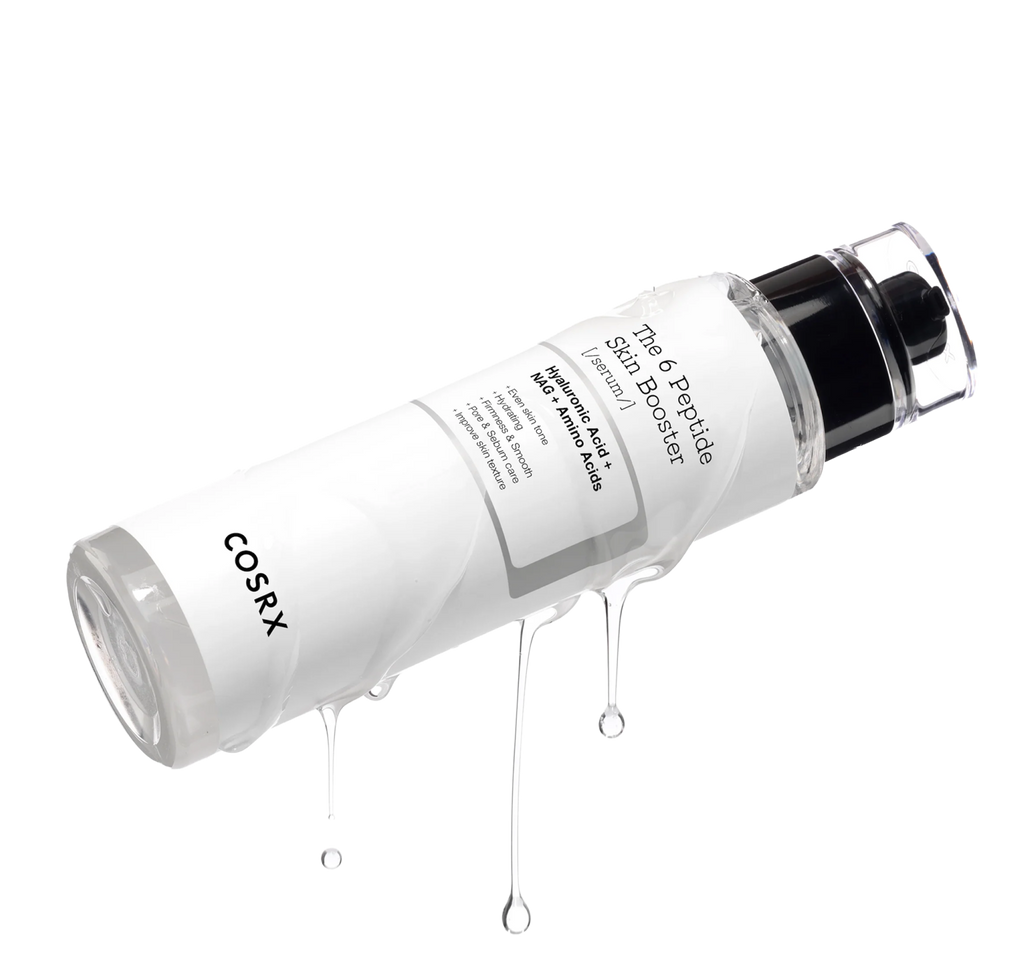 Close-up of COSRX The 6 Peptide Skin Booster Serum bottle angled with clear serum dripping down; clean minimal image showcasing lightweight, hydrating texture of the all-in-one Korean first-step booster that strengthens skin barrier, firms texture, and enhances glow.