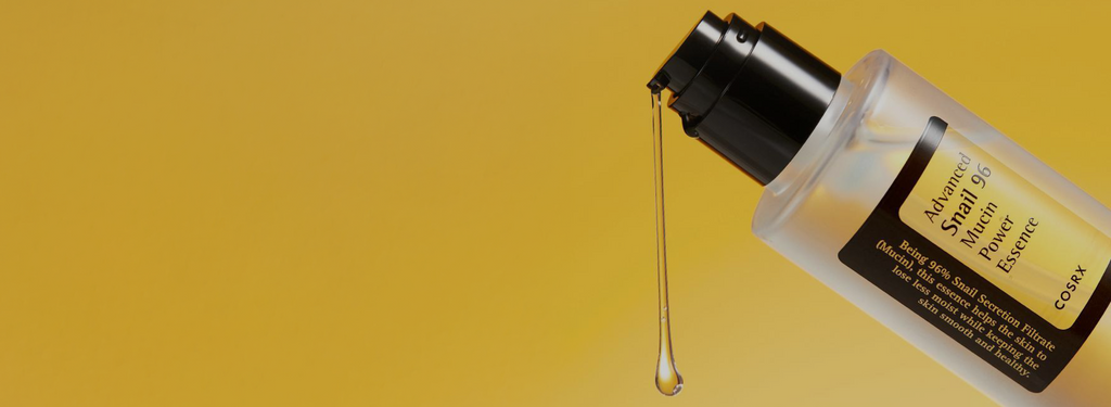 COSRX Advanced Snail 96 Mucin Power Essence shown with drop of serum against golden background; text reading ‘No.1 Global Essence’ highlights its 96% snail secretion filtrate, a glow-boosting Korean skincare formula for instant hydration, radiance, and improved absorption.