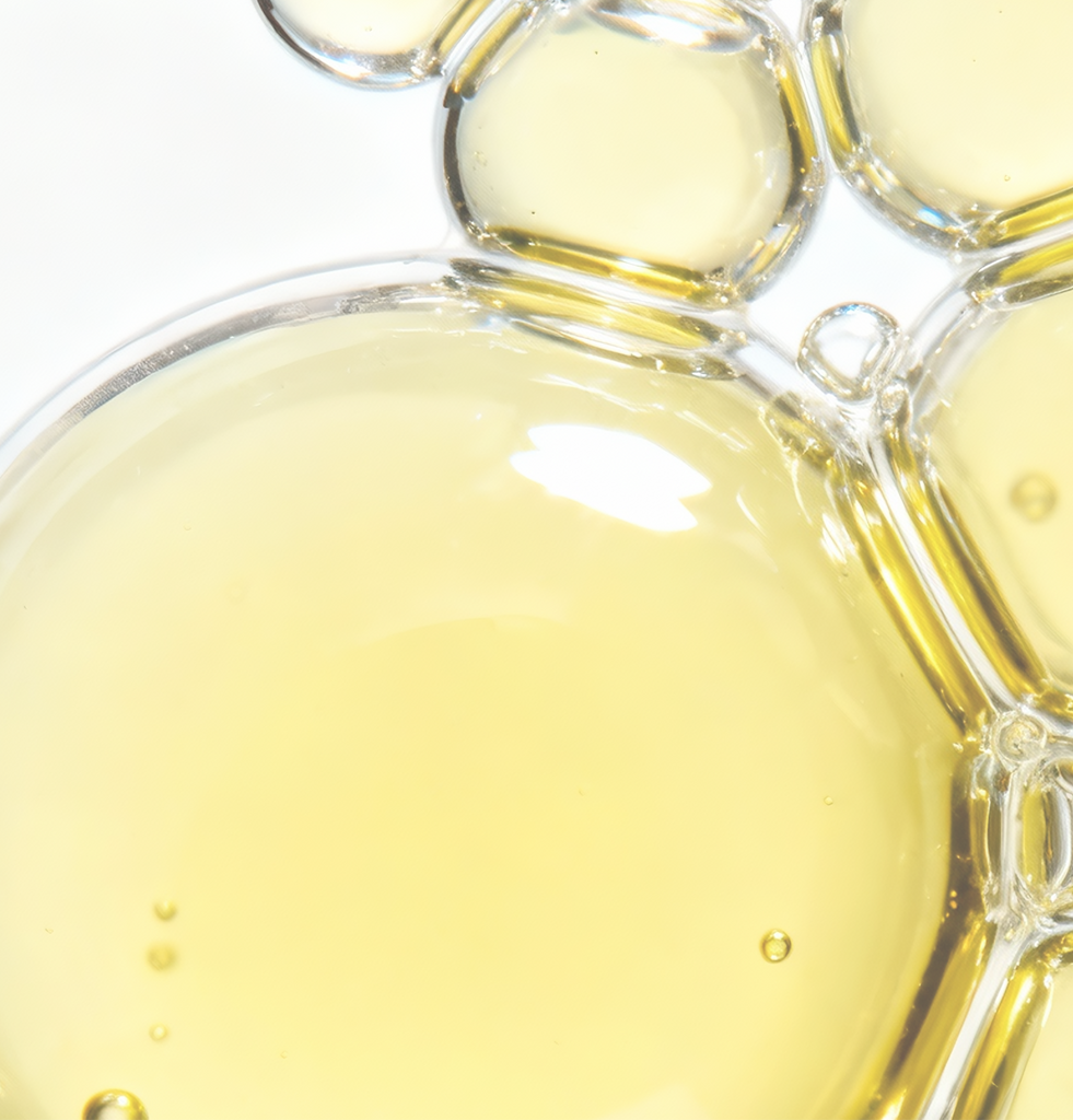 Golden macro shot of COSRX Advanced Snail 96 Mucin Power Essence texture with text ‘96% Snail Secretion Filtrate’; visualizes serum’s active ingredient known to boost skin clarity, radiance, and hydration for improved absorption and elasticity.