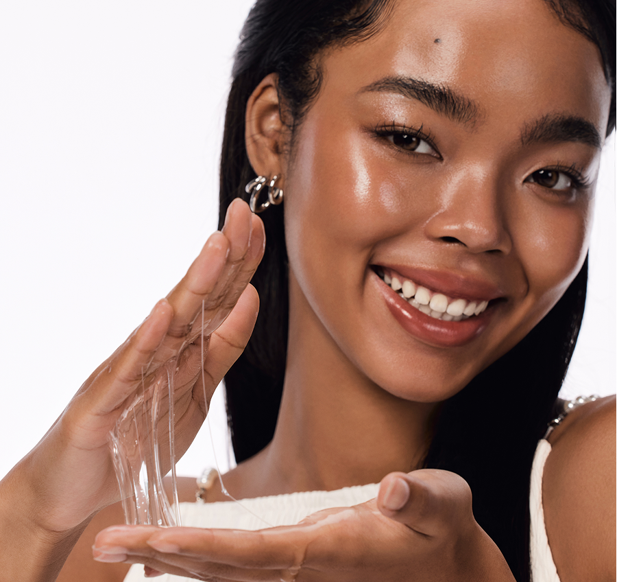 Model applying COSRX Advanced Snail 96 Mucin Power Essence to hands, showing luminous, hydrated skin and dewy finish; lightweight essence with 96% snail secretion filtrate enhances absorption, smooths texture, and supports slow-aging glow in modern K-beauty skincare routines.