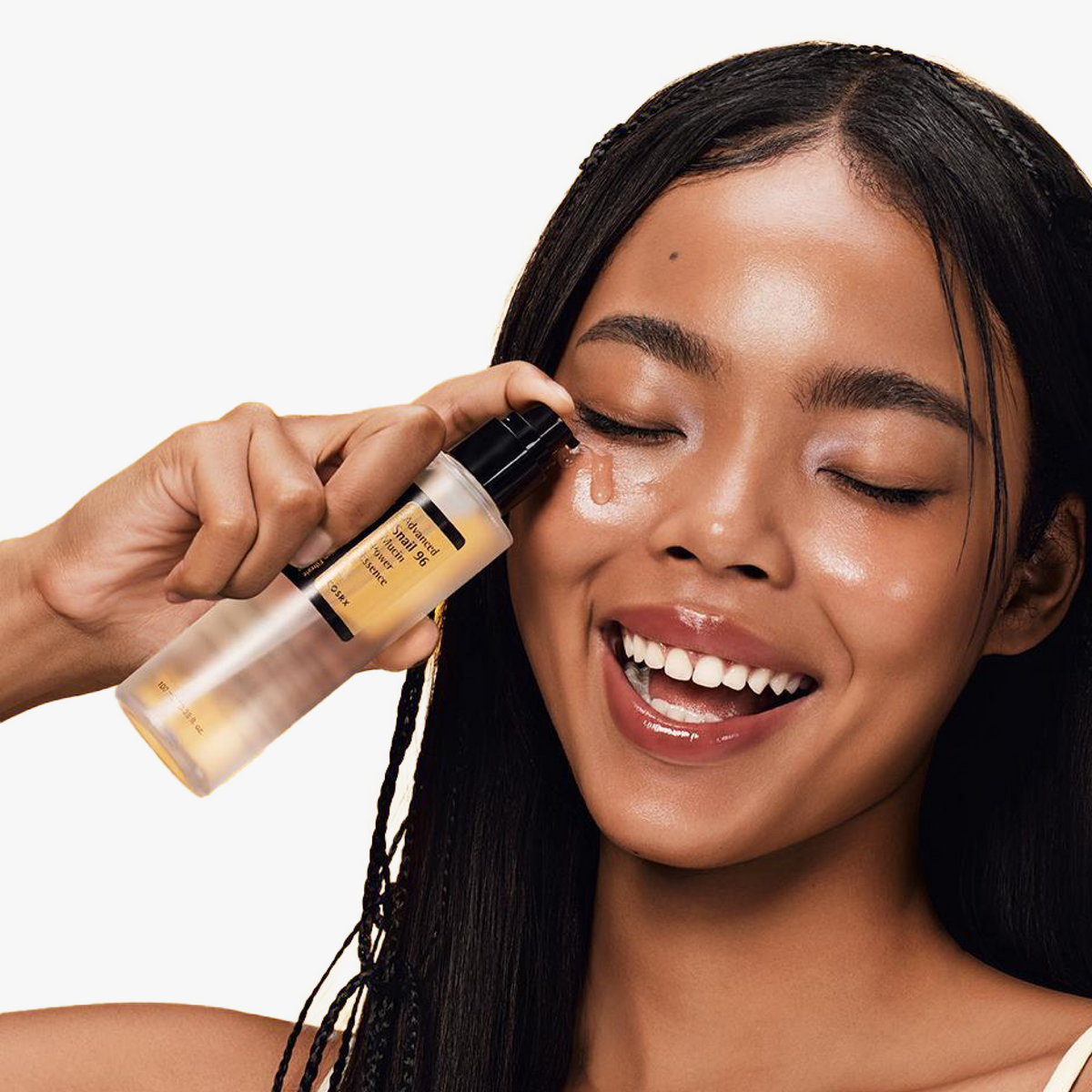 Model applying COSRX Advanced Snail 96 Mucin Power Essence under the eyes, highlighting its lightweight, radiant texture; essence formulated with 96% snail secretion filtrate to boost hydration, elasticity, and skin smoothness. Clinical testing showed a 35.24% increase in skin gloss as measured by the Skin Glossymeter, confirming its radiance-enhancing benefits in slow-aging K-beauty care.