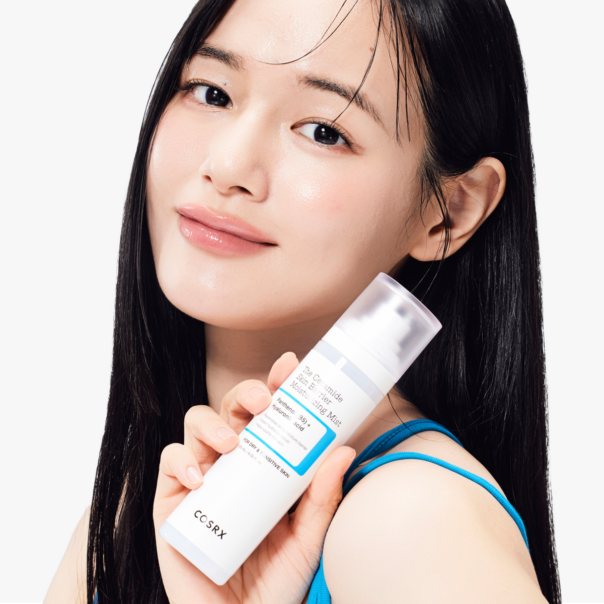 Model with luminous, hydrated skin holding COSRX The Ceramide Skin Barrier Moisturizing Mist; highlights the product’s visible results in restoring moisture and reinforcing the skin barrier with Panthenol and Hyaluronic Acid, clinically proven to enhance stressed skin barrier strength by 107.4% after a single use for smoother, calmer skin.