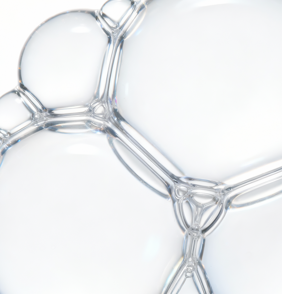 Close-up macro of translucent serum bubbles with text highlighting 15% Niacinamide; visual represents COSRX The Niacinamide 15 Serum formulated to improve uneven skin tone, tighten enlarged pores, and support smoother, balanced skin for oily and acne-prone users.