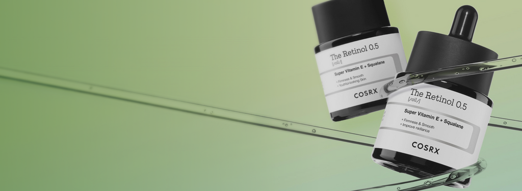 Hero banner showing COSRX The Retinol 0.5 Oil bottles on green background with text ‘0.5% Pure Retinol, For Radiant Anti-Aging Glow’; formulated with Super Vitamin E and Squalane for smoother texture, firmness, and wrinkle repair; ideal for experienced users seeking Korean high-strength retinol.