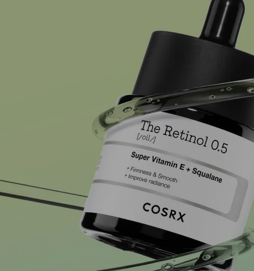 Hero banner showing COSRX The Retinol 0.5 Oil bottles on green background with text ‘0.5% Pure Retinol, For Radiant Anti-Aging Glow’; formulated with Super Vitamin E and Squalane for smoother texture, firmness, and wrinkle repair; ideal for experienced users seeking Korean high-strength retinol.