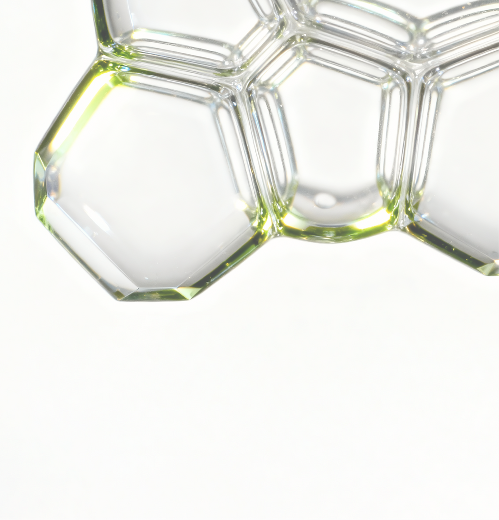 Close-up of hexagonal serum droplets representing COSRX The Retinol 0.5 Oil formula; contains 0.5% pure retinol (vitamin A) to visibly reduce fine lines and support firmer, smoother skin. High-strength Korean retinol booster formulated for experienced users targeting wrinkles and loss of elasticity.
